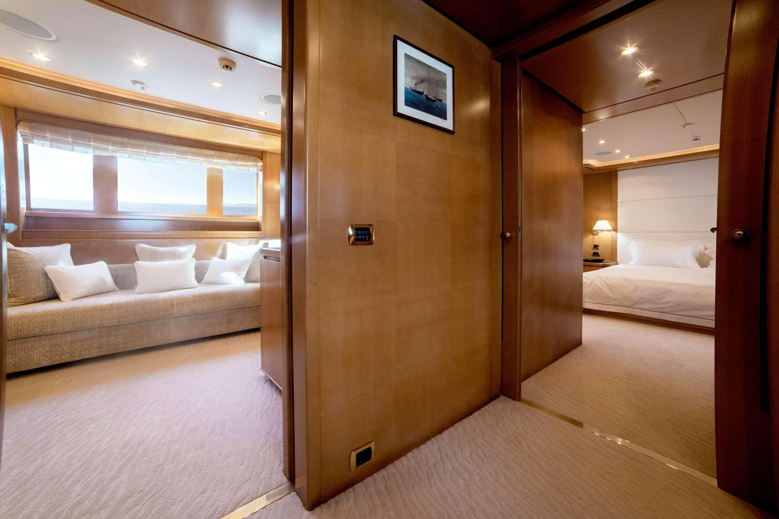 a room with a bed and a couch aboard OASIS Yacht for Sale