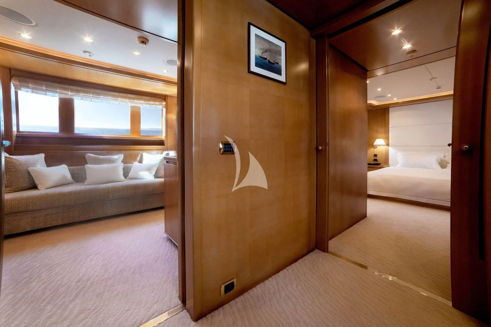 a room with a bed and a couch aboard OASIS Yacht for Sale