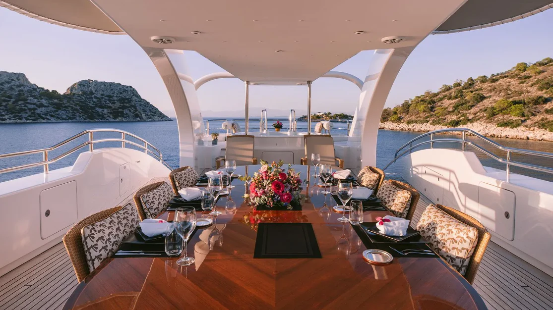 a large dining table on a boat aboard OASIS Yacht for Sale