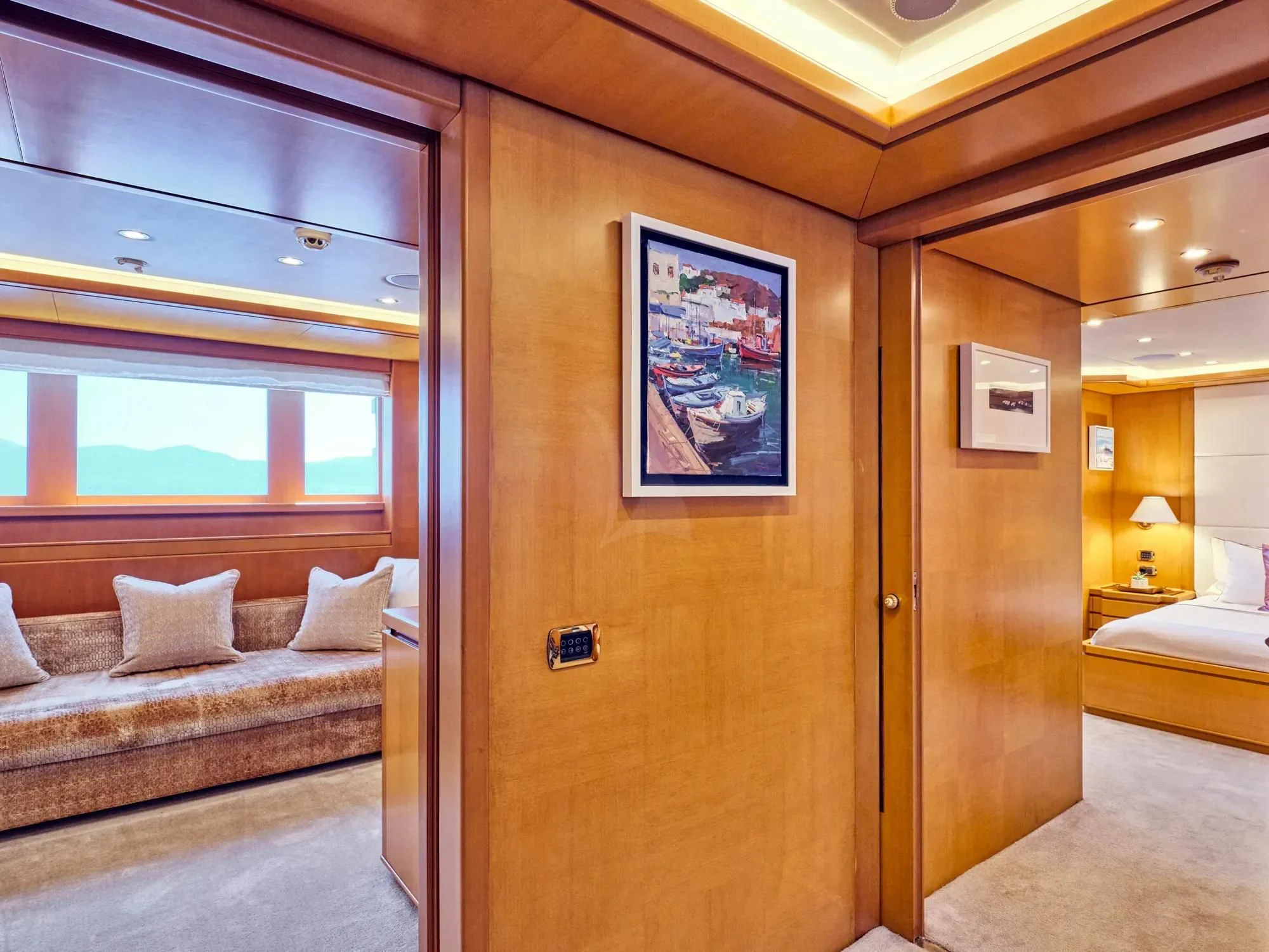 a room with a bed and a couch aboard OASIS Yacht for Sale
