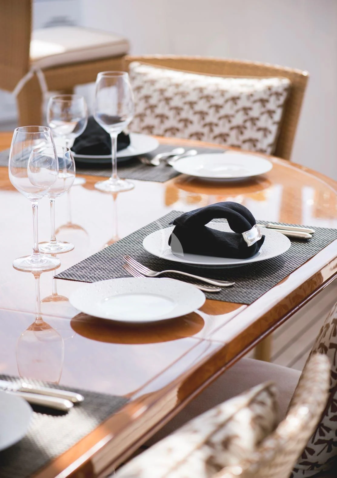 a table with plates and glasses aboard OASIS Yacht for Sale