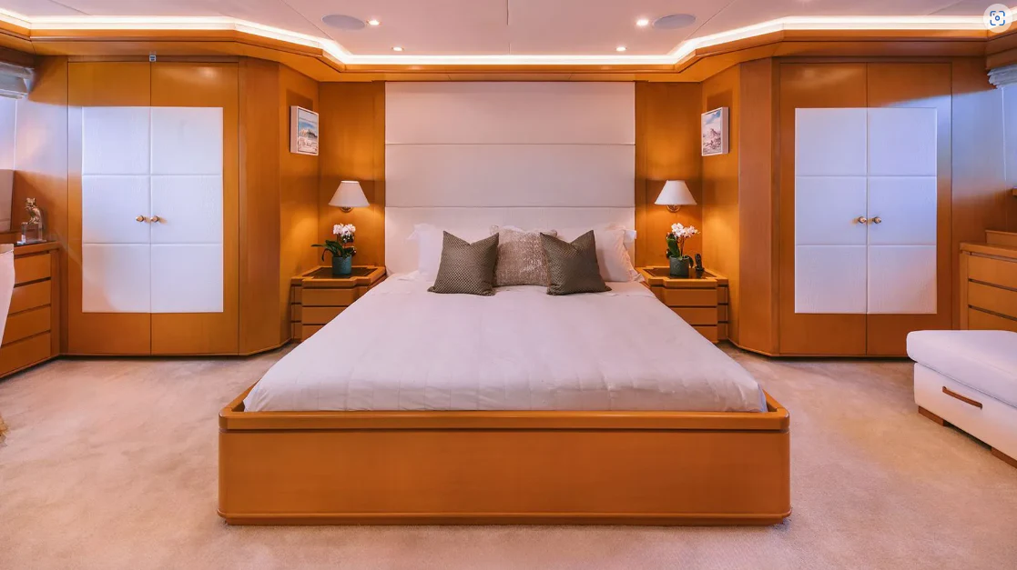 a large bed in a hotel room aboard OASIS Yacht for Sale