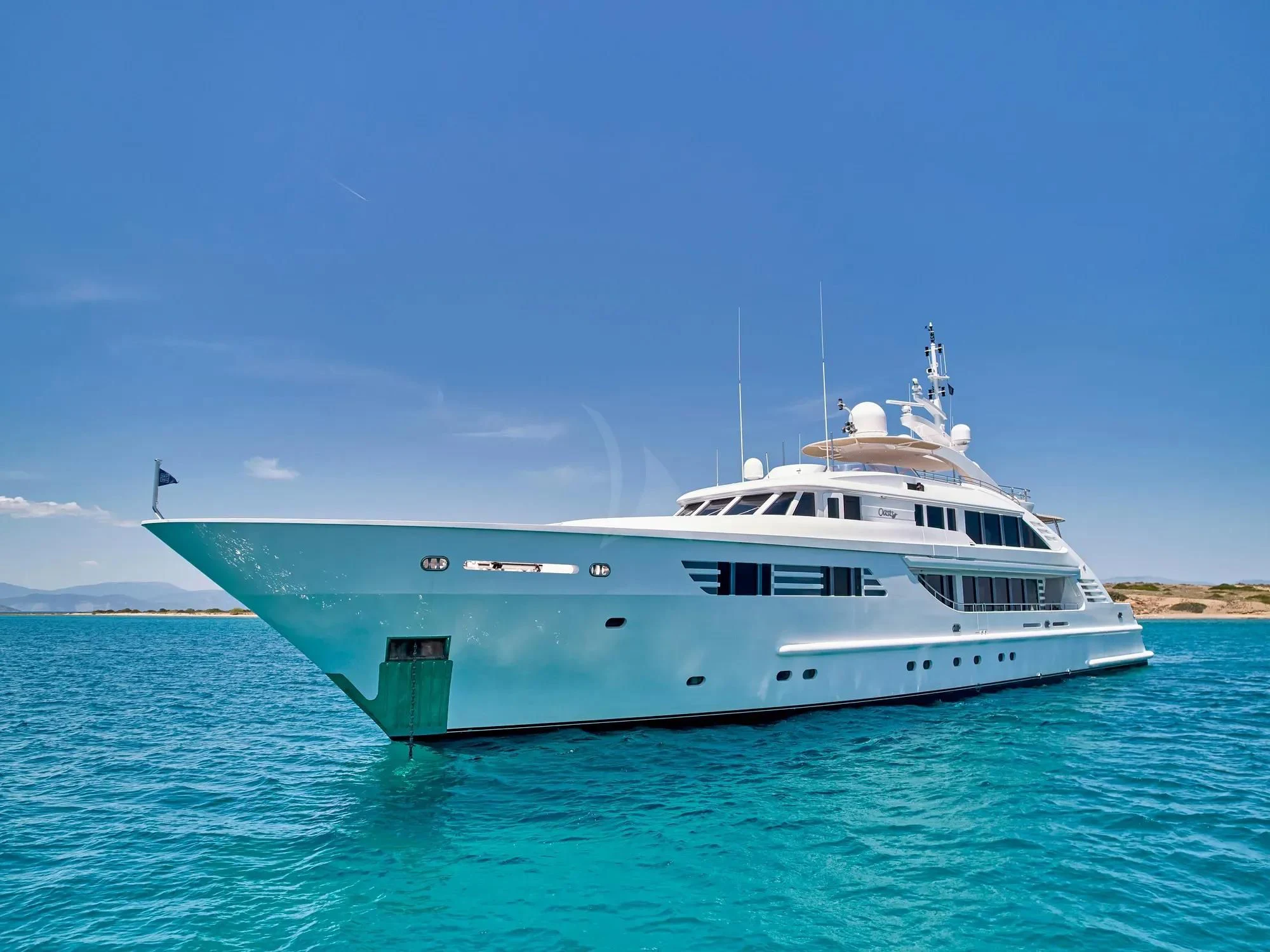 a white boat in the water aboard OASIS Yacht for Sale