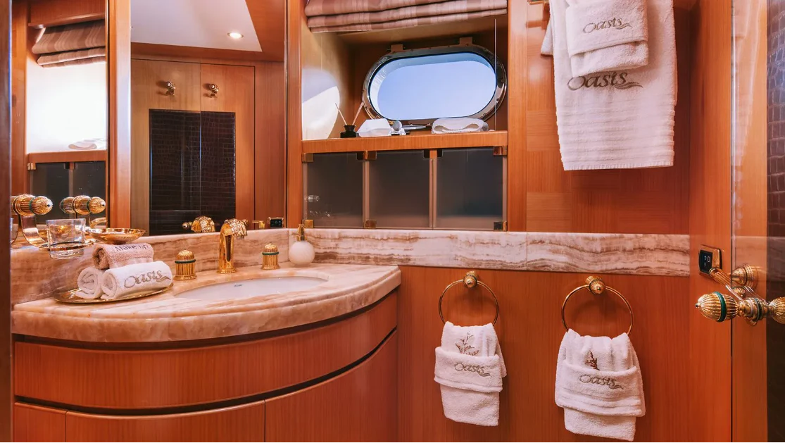 a bathroom with a sink and towels aboard OASIS Yacht for Sale