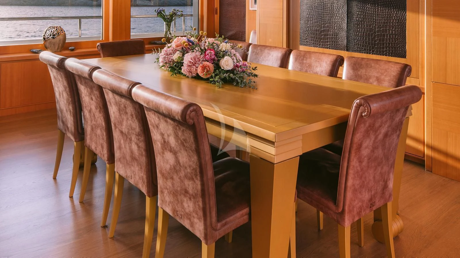 a table with chairs around it aboard OASIS Yacht for Sale