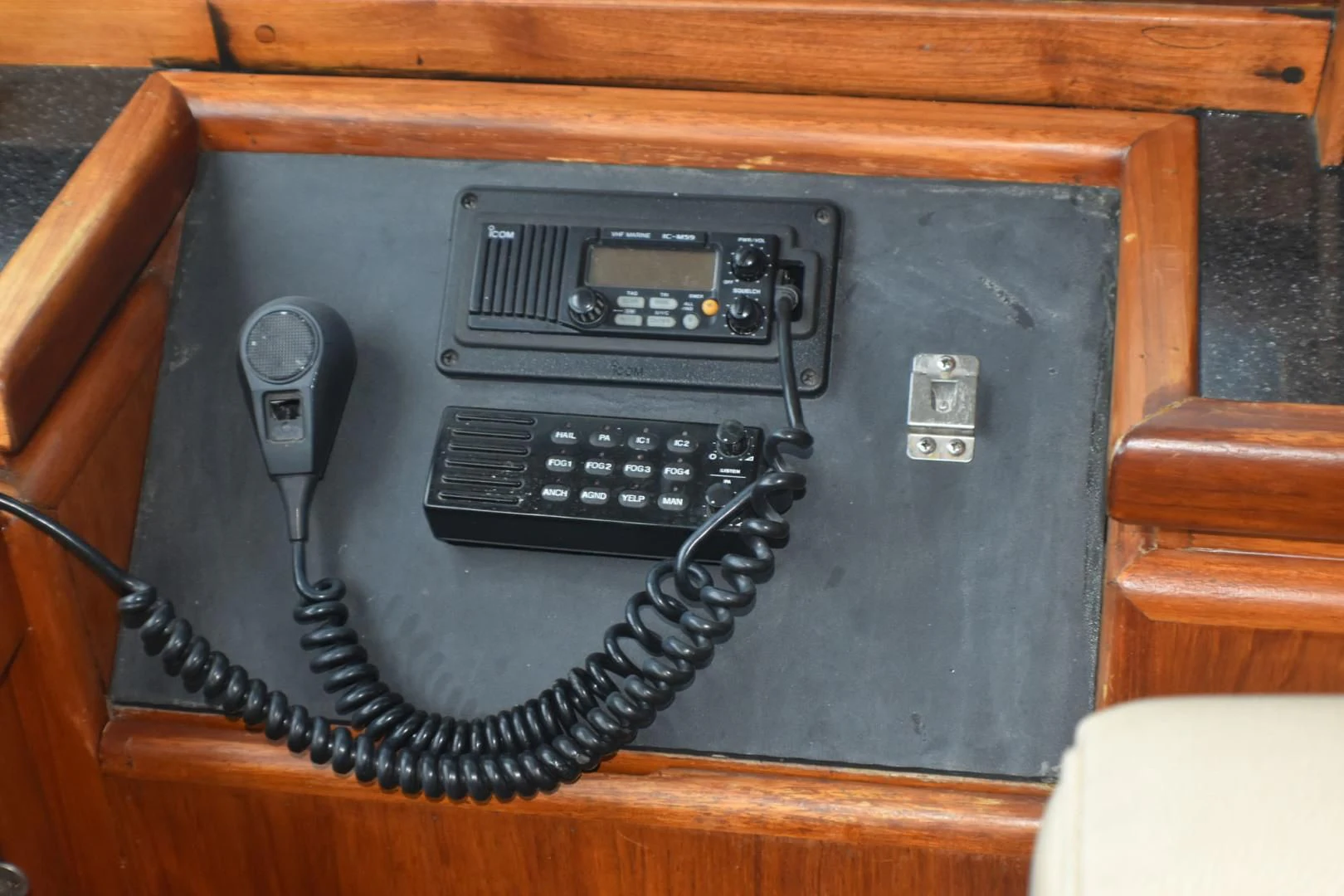 a black electronic device on a wooden table aboard JEWEL OF THE NILE Yacht for Sale
