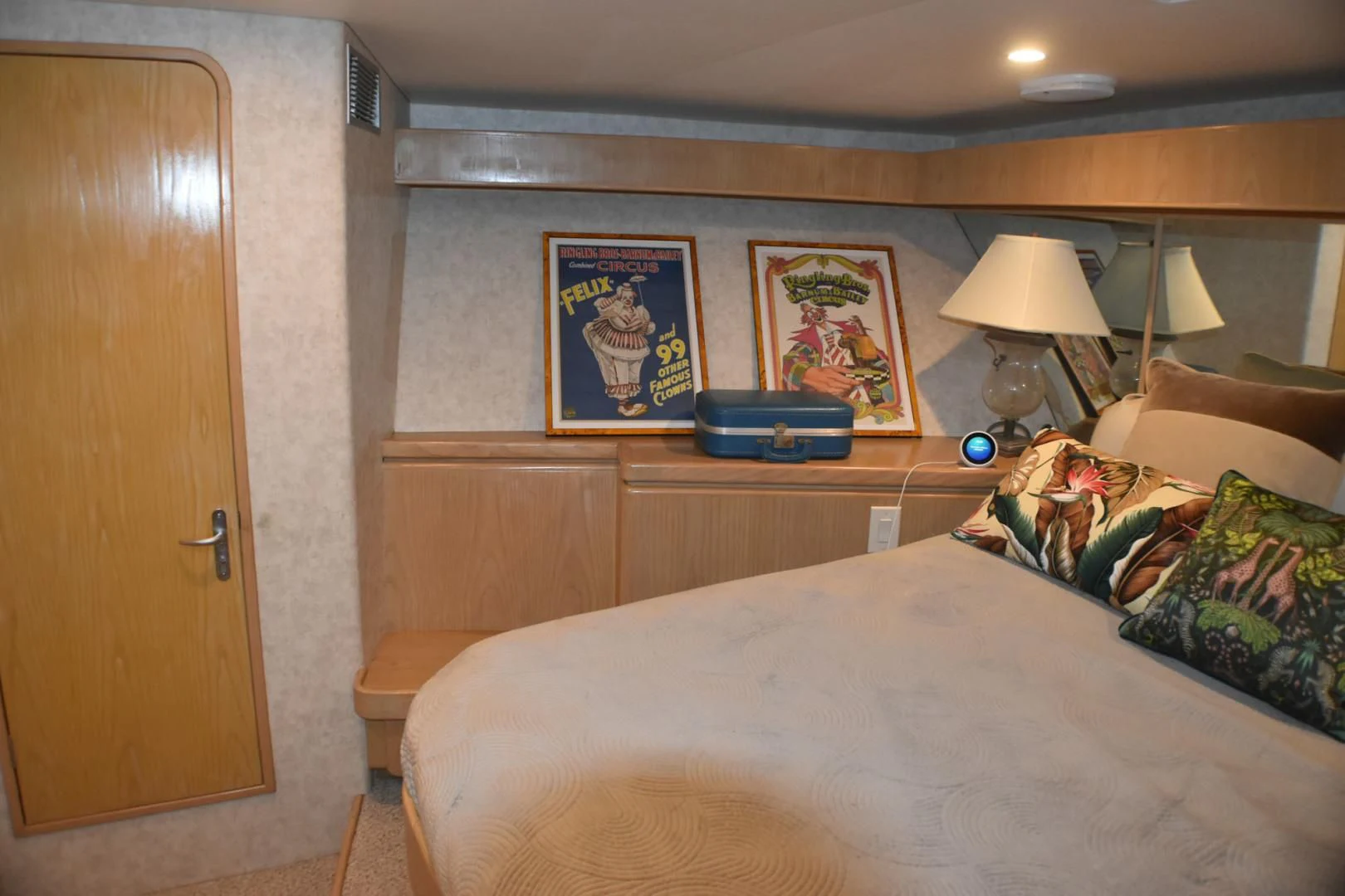 a bedroom with a bed and a lamp on a desk aboard JEWEL OF THE NILE Yacht for Sale
