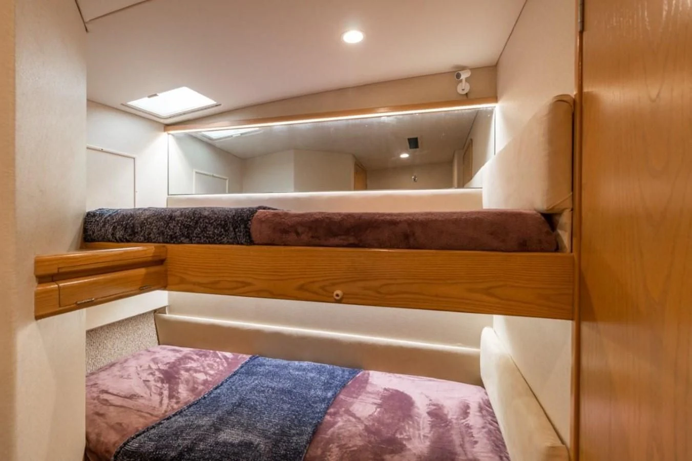 a bed with a wooden frame aboard JEWEL OF THE NILE Yacht for Sale