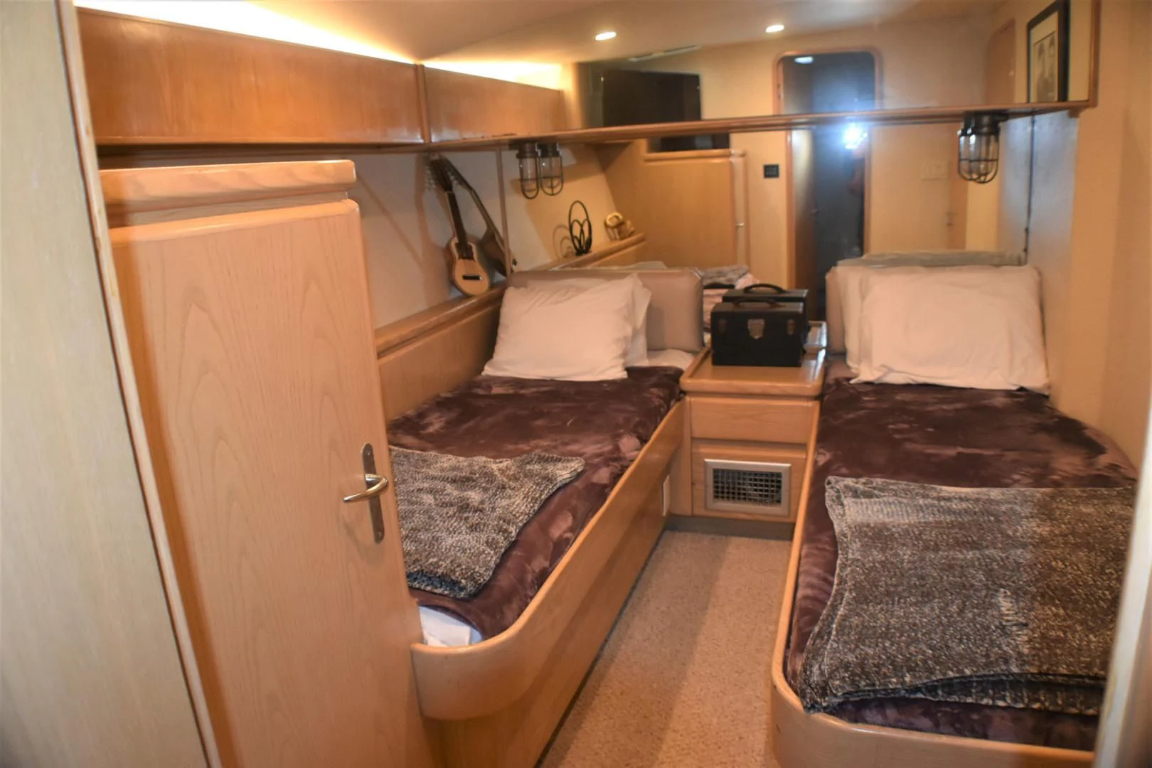 a bedroom with a bed and a dresser aboard JEWEL OF THE NILE Yacht for Sale