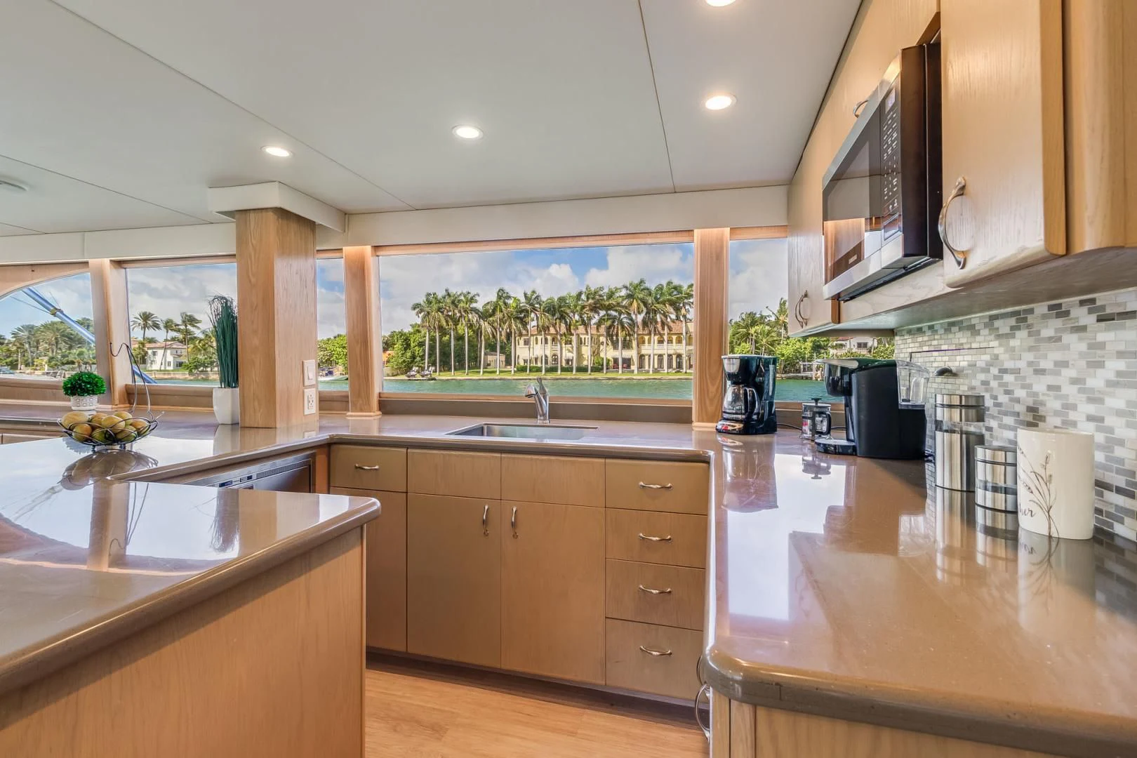 a kitchen with wooden cabinets aboard JEWEL OF THE NILE Yacht for Sale