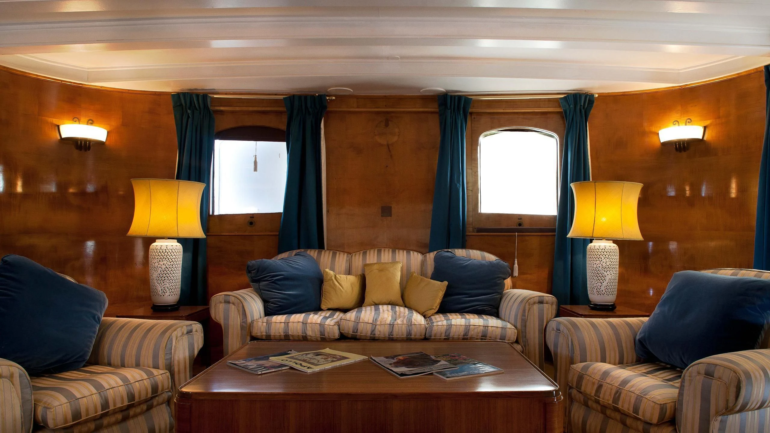 a living room with a couch and a coffee table aboard SHEMARA Yacht for Sale