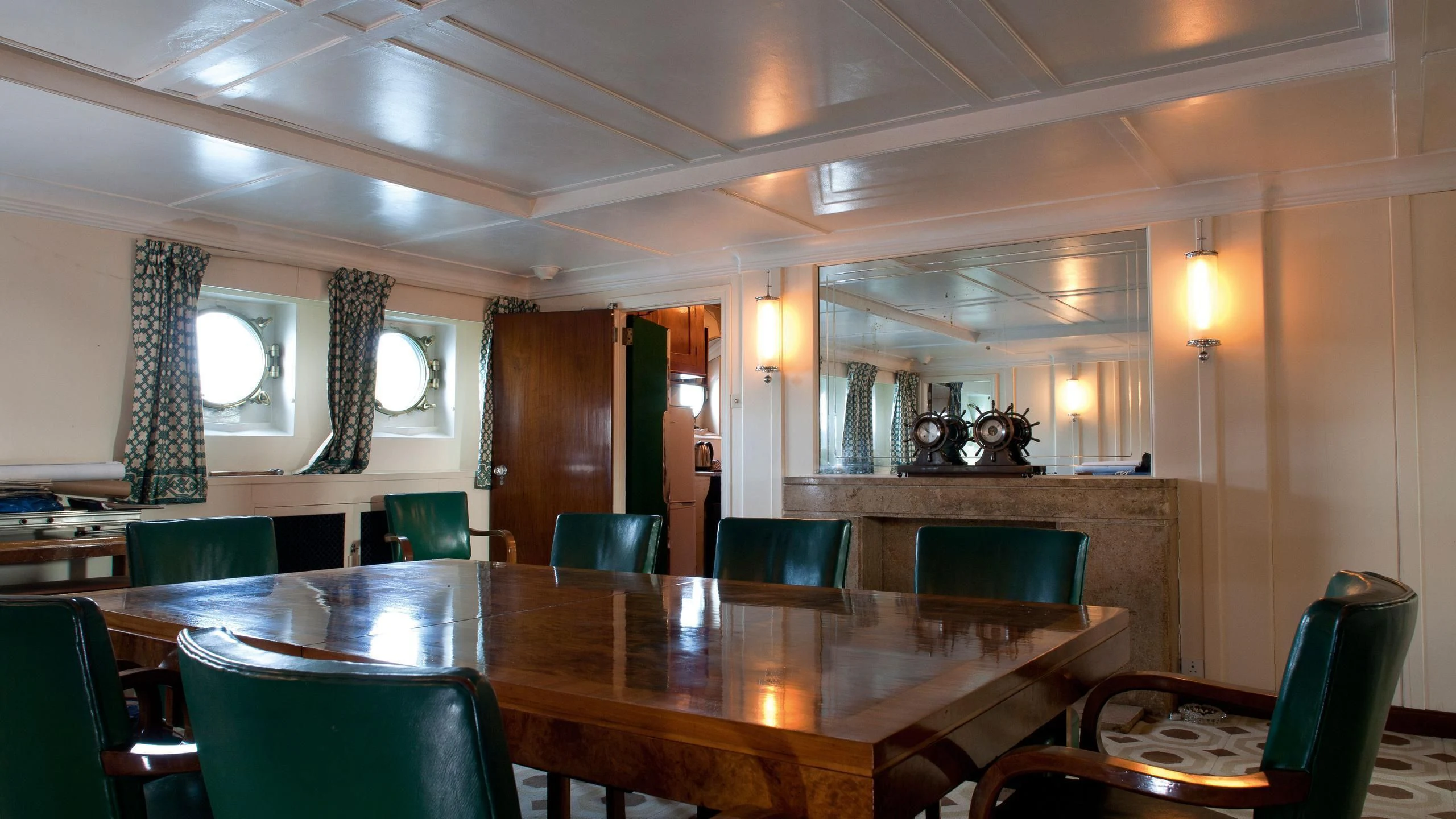 a large room with tables and chairs aboard SHEMARA Yacht for Sale