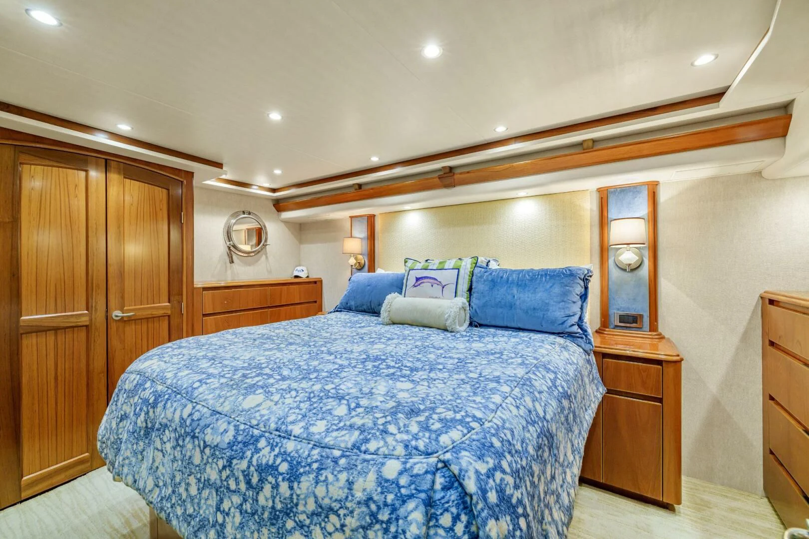 a bed with blue sheets aboard LIFE IS GOOD Yacht for Sale