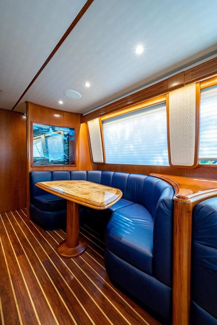 a living room with a blue couch aboard LIFE IS GOOD Yacht for Sale