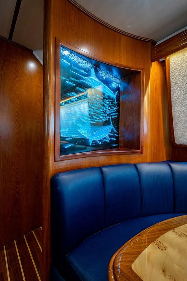 a room with a table and a painting on the wall aboard LIFE IS GOOD Yacht for Sale
