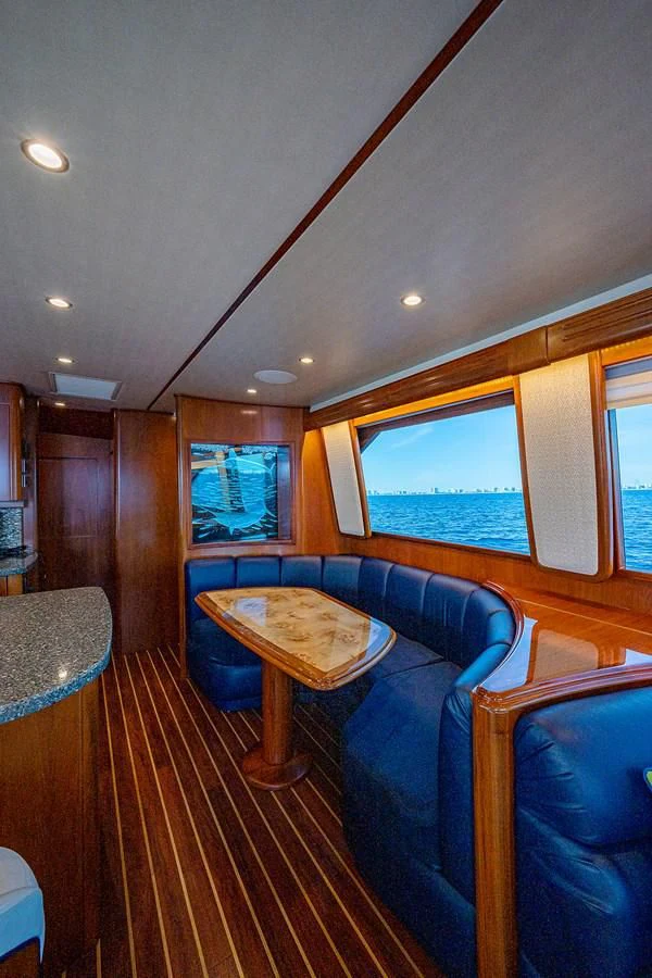 a room with a table and chairs aboard LIFE IS GOOD Yacht for Sale