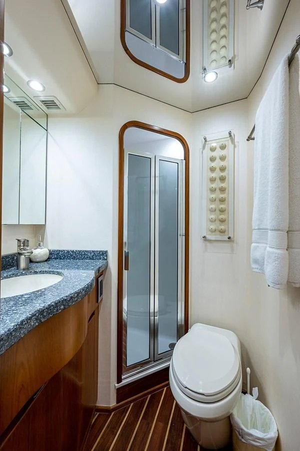 a bathroom with a glass shower door aboard LIFE IS GOOD Yacht for Sale