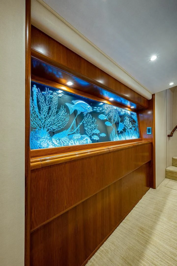 a wood cabinet with blue art aboard LIFE IS GOOD Yacht for Sale