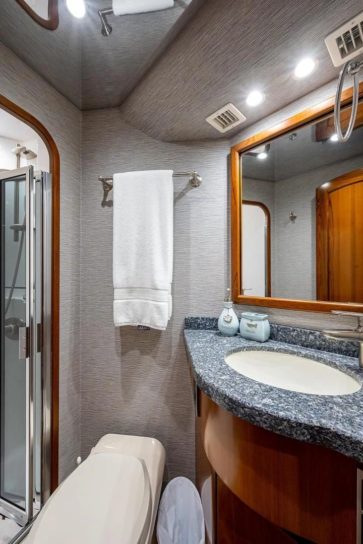 a bathroom with a sink and a mirror aboard LIFE IS GOOD Yacht for Sale
