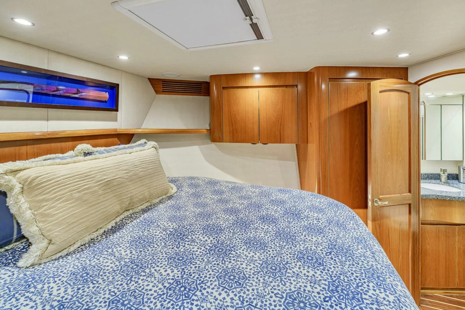 a bed with a wooden headboard aboard LIFE IS GOOD Yacht for Sale