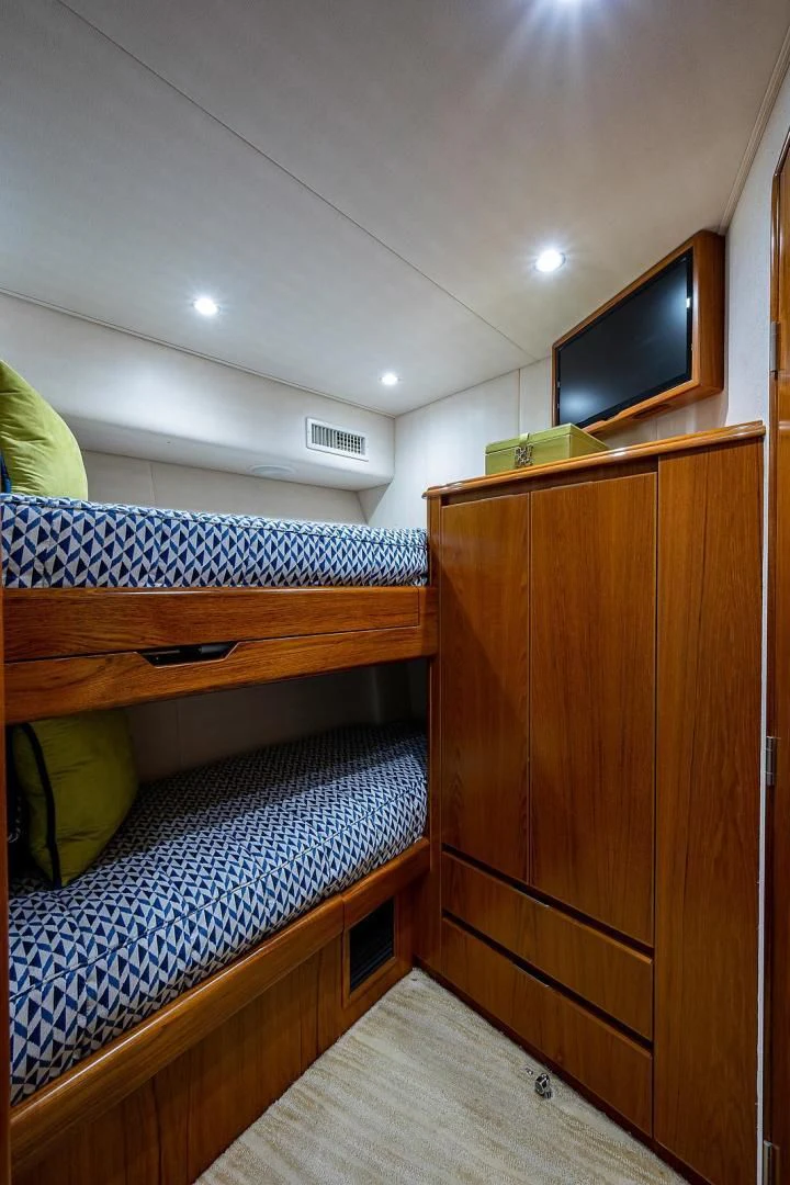a bedroom with a wood cabinet aboard LIFE IS GOOD Yacht for Sale