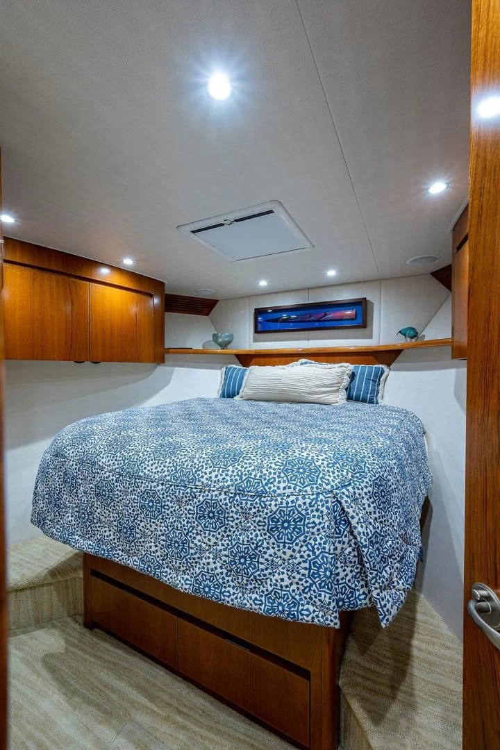 a bed with a blue comforter aboard LIFE IS GOOD Yacht for Sale