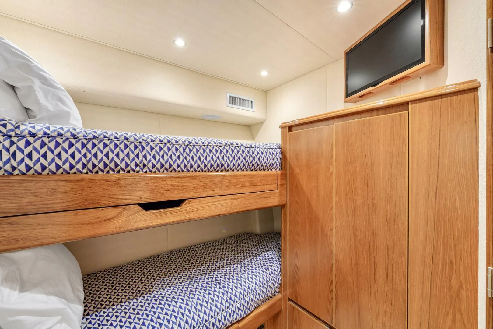 a bed with a wood headboard aboard LIFE IS GOOD Yacht for Sale