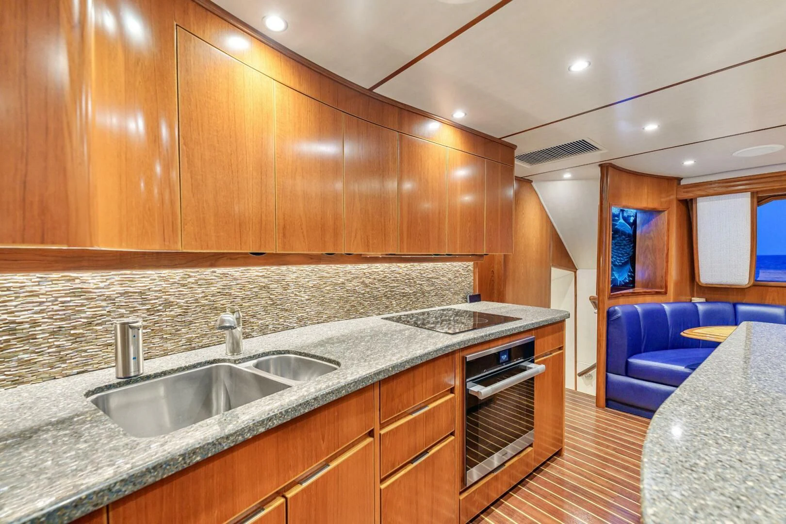 a kitchen with wooden cabinets aboard LIFE IS GOOD Yacht for Sale