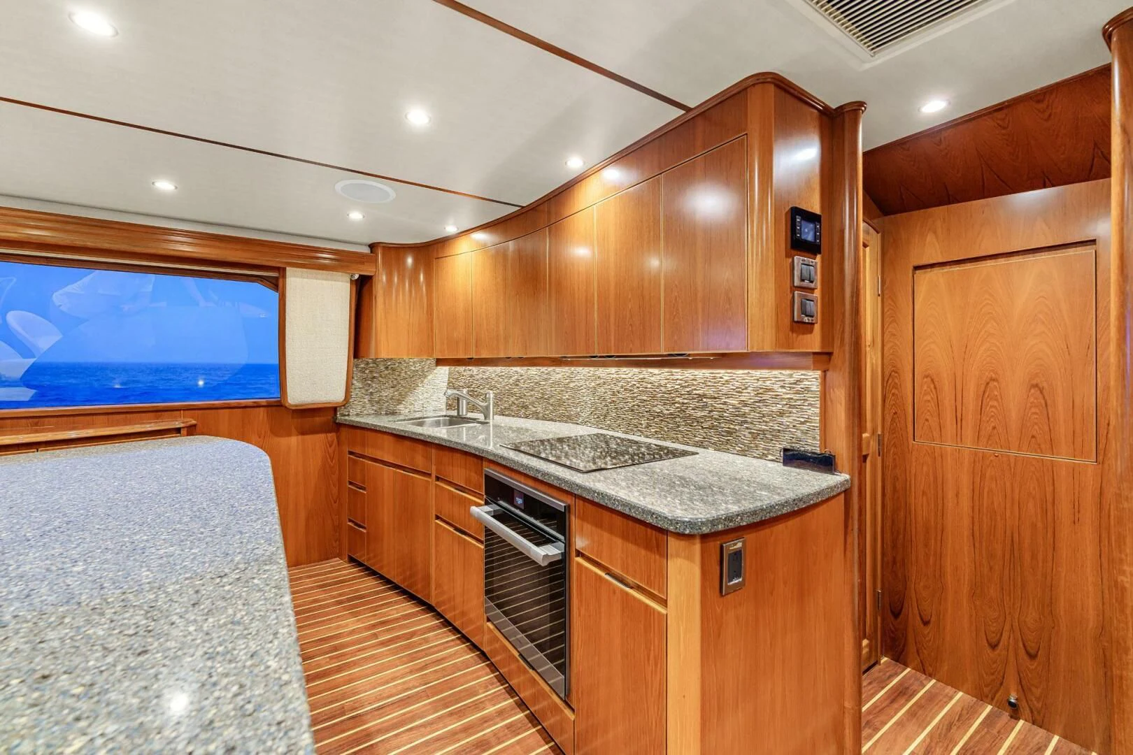 a kitchen with wooden cabinets aboard LIFE IS GOOD Yacht for Sale