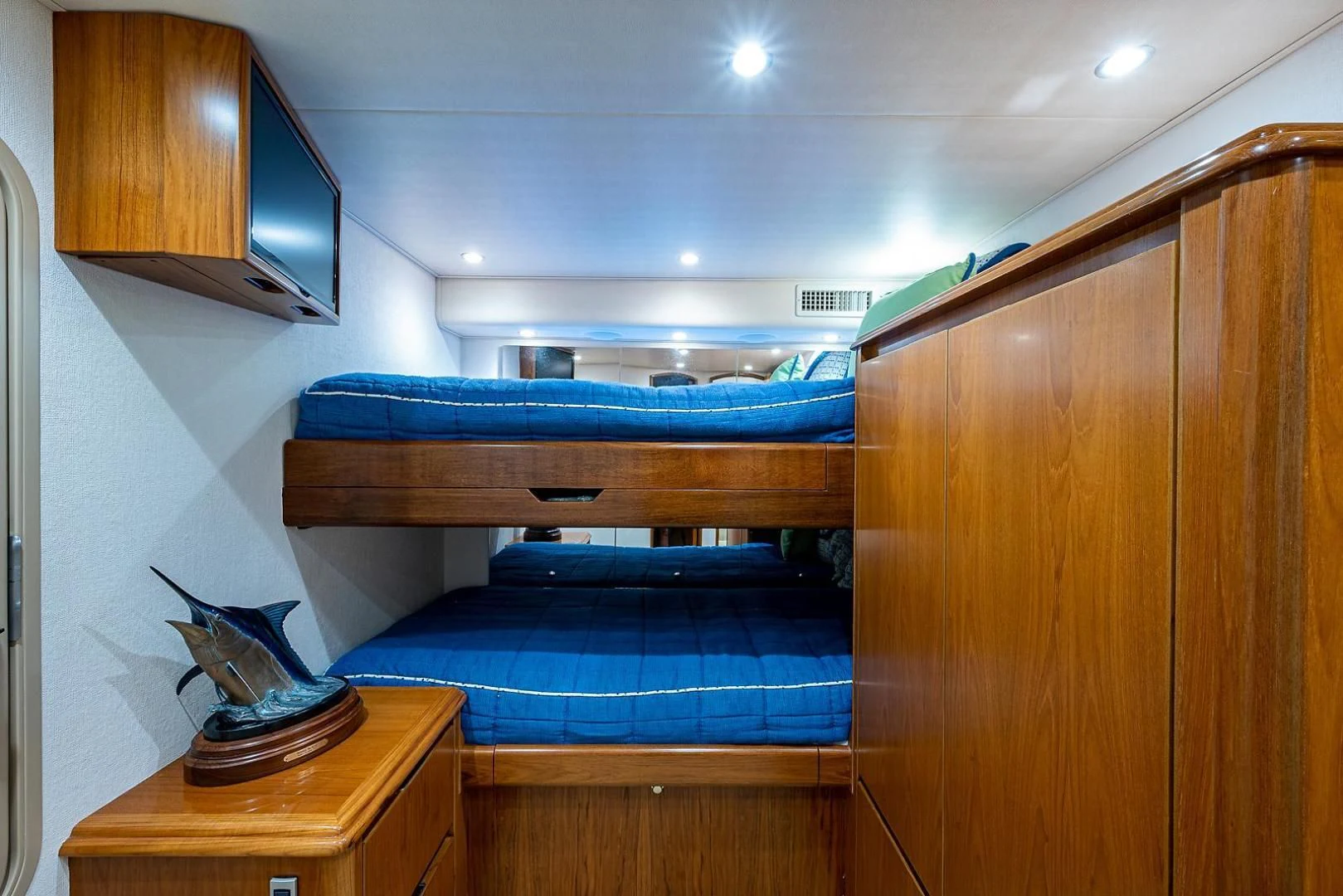 a room with a bed and a television aboard LIFE IS GOOD Yacht for Sale