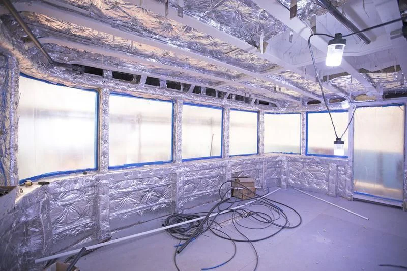 a room with a large wall of windows and a few chairs aboard RENATA Yacht for Sale