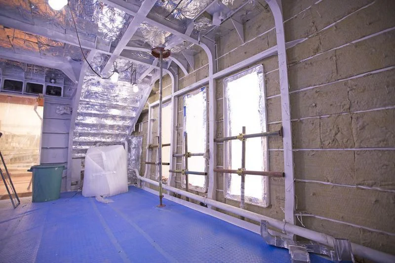 a room with a brick wall and windows aboard RENATA Yacht for Sale