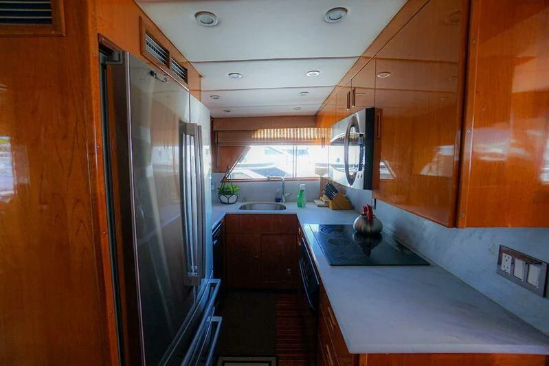 a kitchen with a large island aboard MOMMA BEAR Yacht for Sale