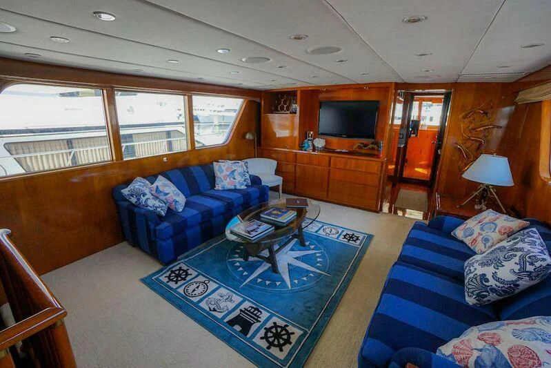 a living room with a blue couch aboard MOMMA BEAR Yacht for Sale