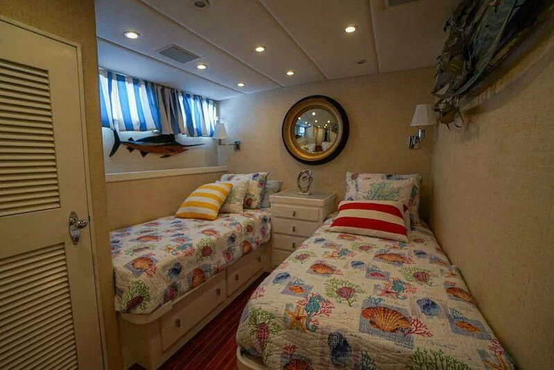 a bedroom with a bed and a mirror aboard MOMMA BEAR Yacht for Sale