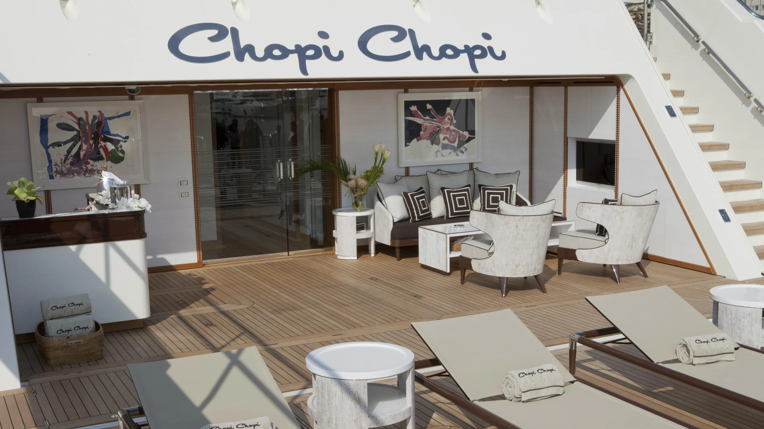 a room with tables chairs and a wood floor aboard CHOPI CHOPI Yacht for Sale