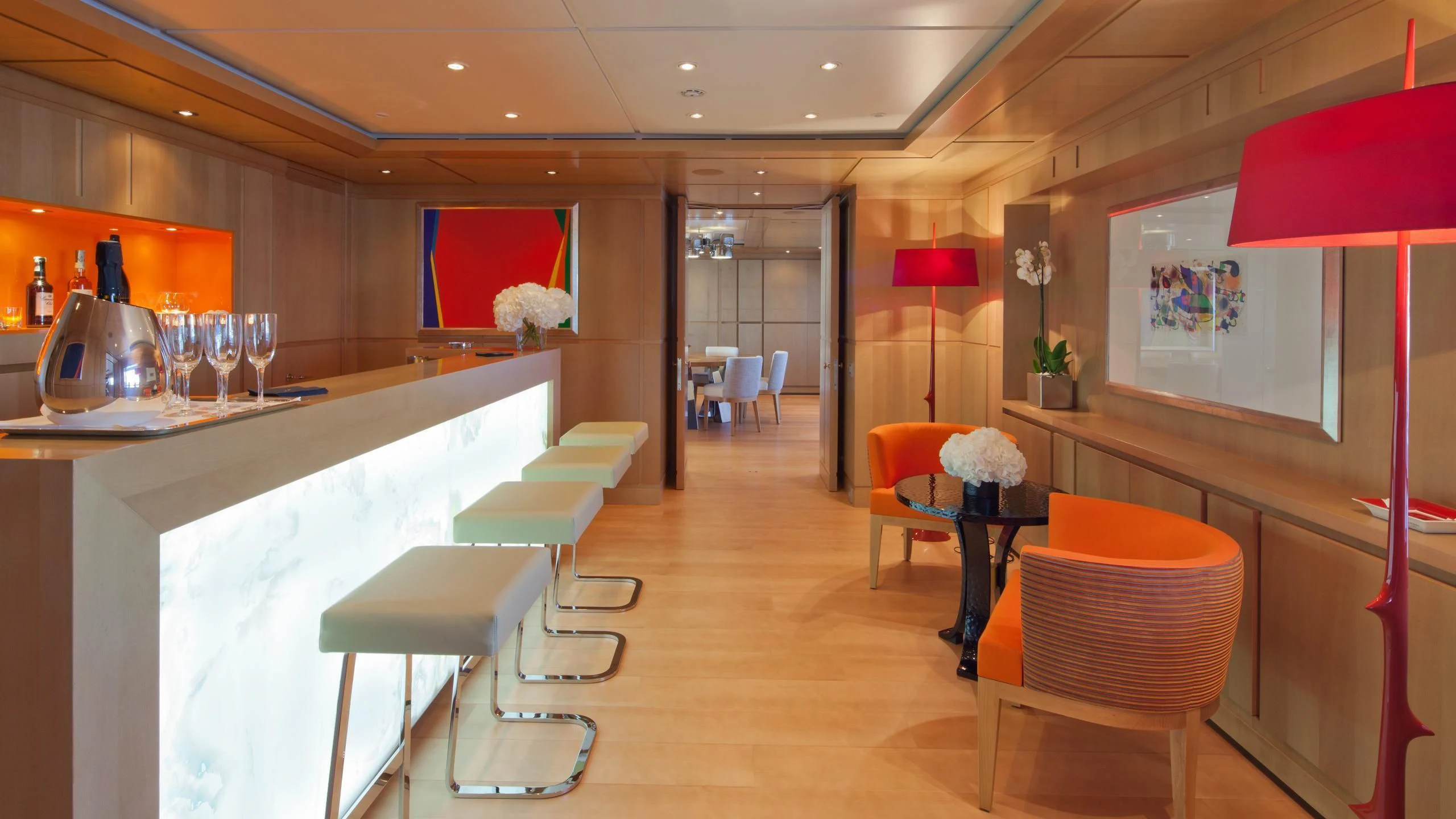 a room with tables chairs and a television aboard CHOPI CHOPI Yacht for Sale