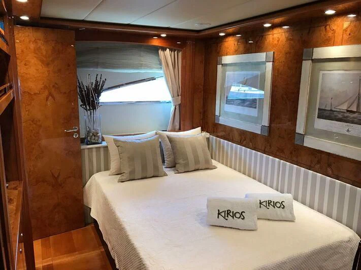 a bed with a white sheet and pillows on it aboard KIRIOS Yacht for Sale