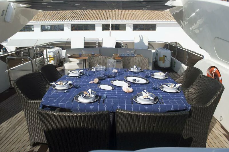 a table set for a dinner aboard KIRIOS Yacht for Sale