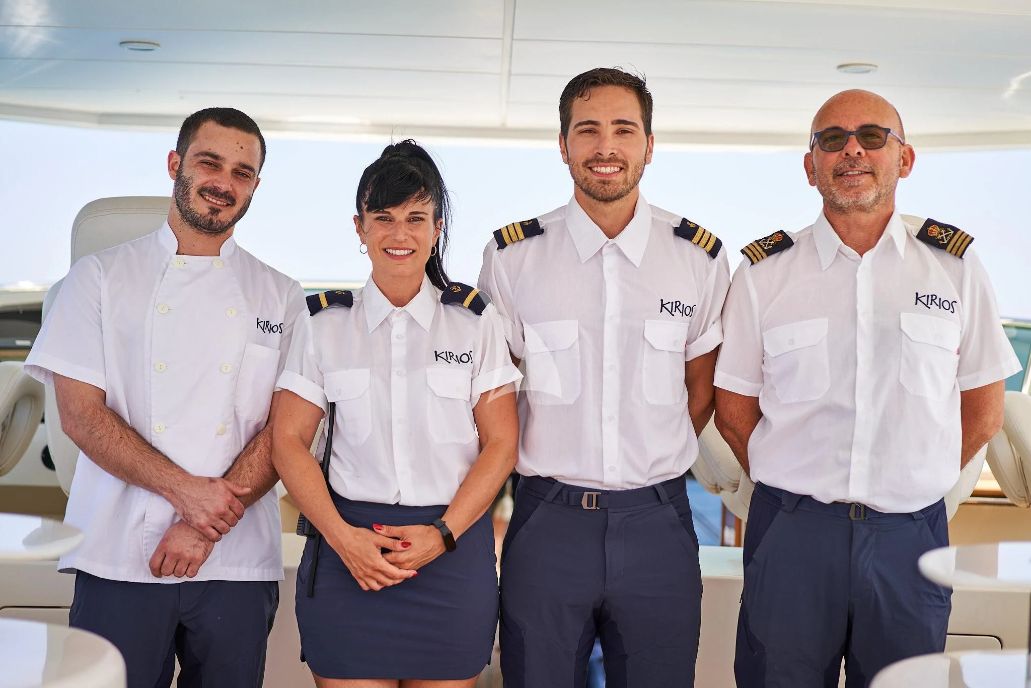 a group of men posing for a photo aboard KIRIOS Yacht for Sale