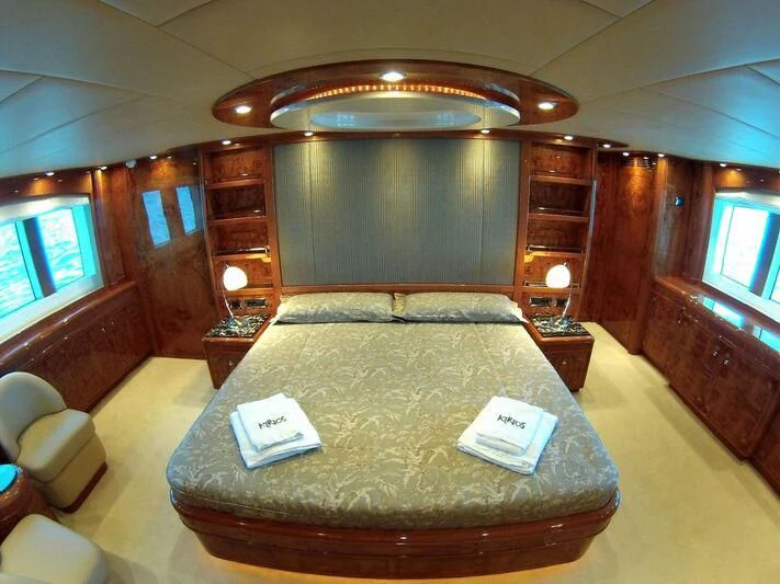a bed with a book on it aboard KIRIOS Yacht for Sale