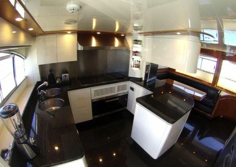 a kitchen with stainless steel appliances aboard KIRIOS Yacht for Sale