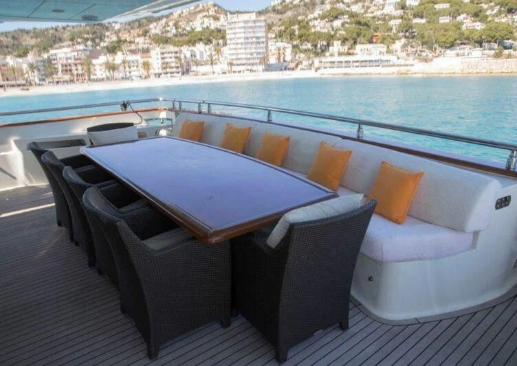 a table and chairs on a deck aboard KIRIOS Yacht for Sale