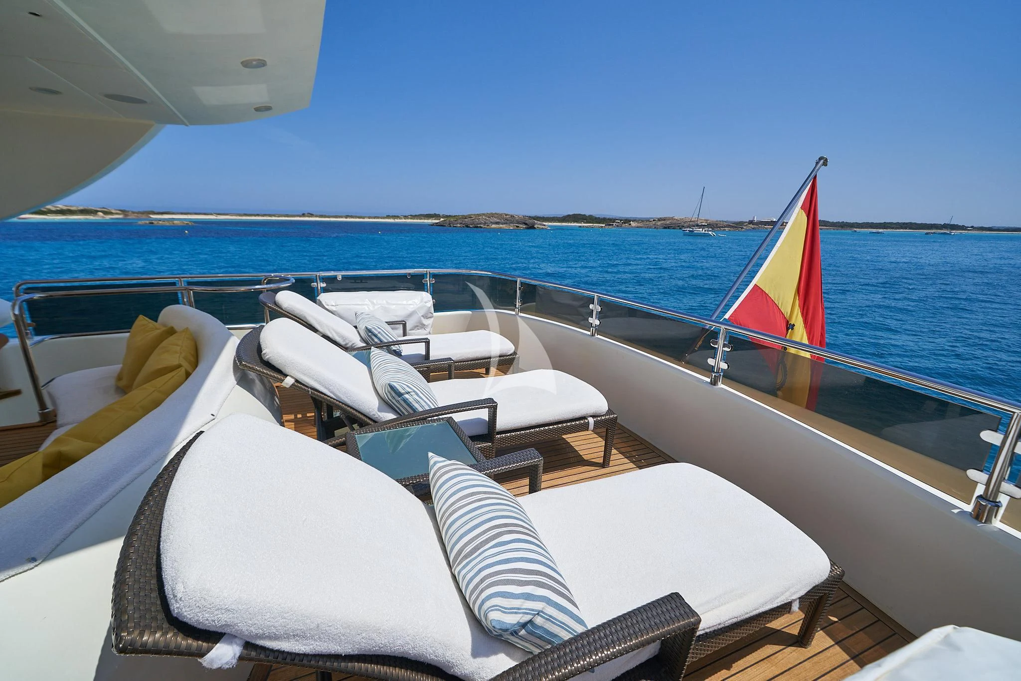 a boat with chairs and umbrellas on it aboard KIRIOS Yacht for Sale
