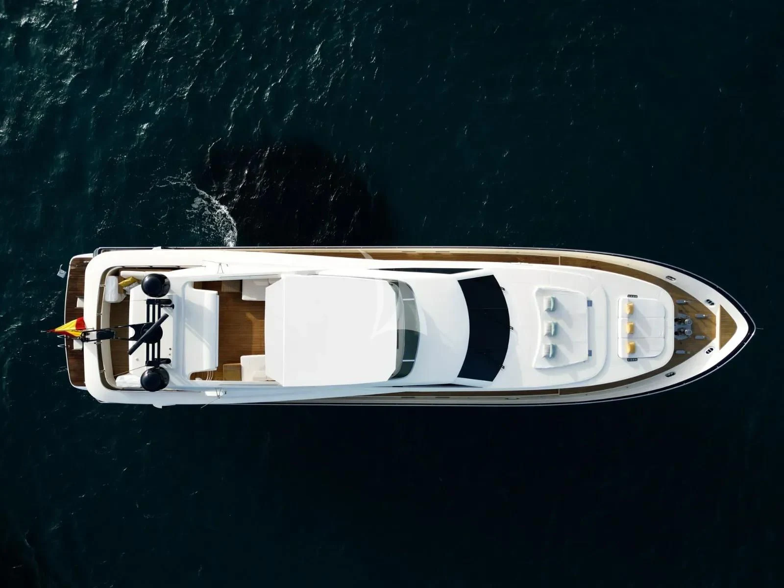 a white boat with black and yellow stripes on it aboard KIRIOS Yacht for Sale