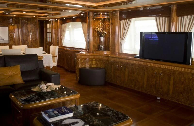a living room with a large screen aboard KIRIOS Yacht for Sale