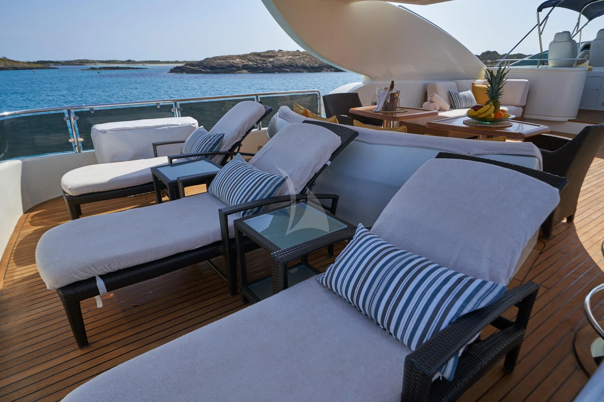 a room with a table chairs and a large umbrella aboard KIRIOS Yacht for Sale