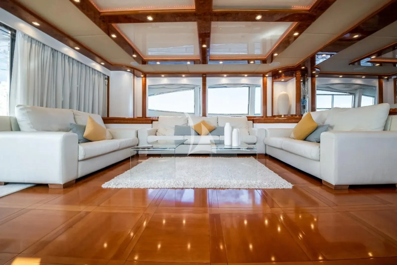 a large living room with a large wood floor aboard KIRIOS Yacht for Sale