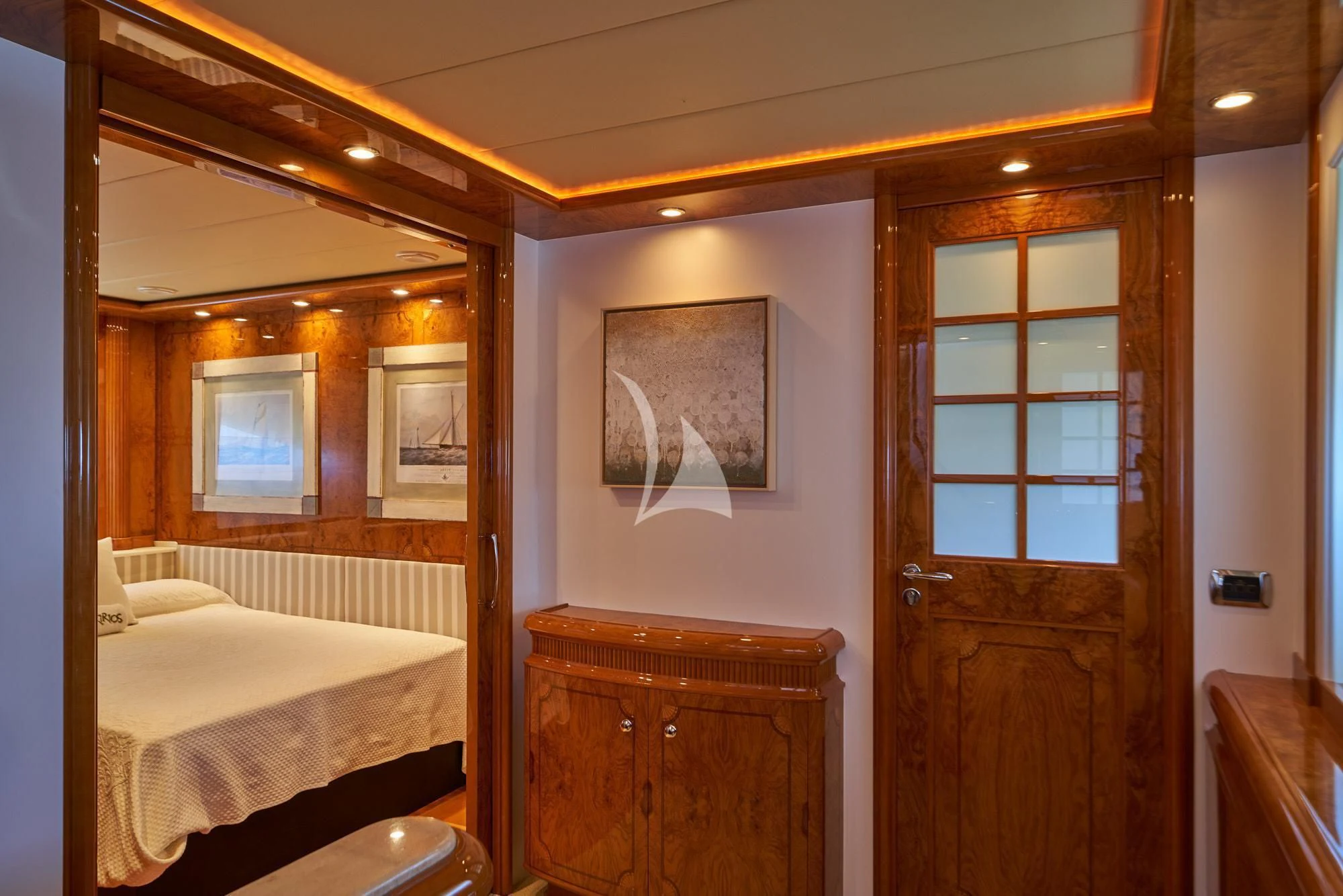 a bedroom with a wood door aboard KIRIOS Yacht for Sale