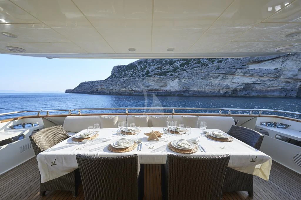 a table set for a dinner on a boat aboard KIRIOS Yacht for Sale